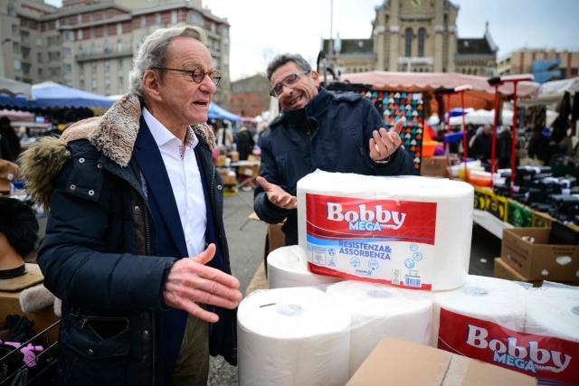 Mayor of Grenoble and Les Republicains' lead candidate for his re-election, Alain Carignon (L) speaks with a local resident as he distributes campaign leaflets at a market in Grenoble on February 7, 2026. (Photo by OLIVIER CHASSIGNOLE / AFP)