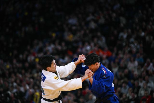 France's Dayyan Boulemtafes (R) competes against Japan's Tatsuki Ishihara (L) during the men's -73kg quarter-final at the Paris Grand Slam judo tournament in Paris on February 7, 2026. (Photo by Julie SEBADELHA / AFP)