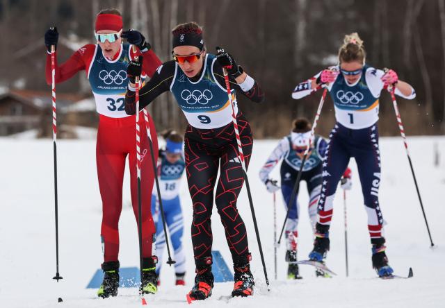 (From L) Switzerland's Marina Kaelin, Germany's Pia Fink and USA's Jessie Diggins compete during the women's cross country 10km + 10km skiathlon event of the Milano Cortina 2026 Winter Olympic Games at Tesero Cross-Country Skiing Stadium in Lago di Tesero (Val di Fiemme) on February 7, 2026. (Photo by Anne-Christine POUJOULAT / AFP)