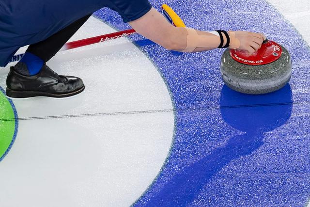 Britain's Bruce Mouat competes in the curling mixed doubles round robin between Britain and Canada during the Milano Cortina 2026 Winter Olympic Games at the Cortina Curling Olympic Stadium in Cortina d’Ampezzo on February 7, 2026. (Photo by Odd ANDERSEN / AFP)