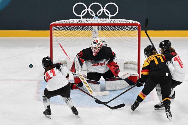 Japan's goalkeeper #31 Riko Kawaguchi and Japan's #41 Riri Noro (L) defend the goal during the women's preliminary round Group B Ice Hockey match between Germany and Japan at the Milano Rho Ice Hockey Arena at the Milano Cortina 2026 Winter Olympic Games in Milan, on February 7, 2026. (Photo by Alexander NEMENOV / AFP)