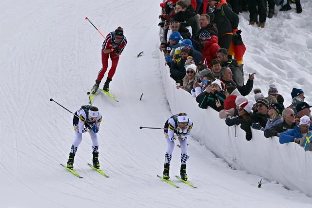 (From L) Sweden's Ebba Andersson, Norway's Astrid Oeyre Slind and Sweden's Frida Karlsson compete during the women's cross country 10km + 10km skiathlon event of the Milano Cortina 2026 Winter Olympic Games at Tesero Cross-Country Skiing Stadium in Lago di Tesero (Val di Fiemme) on February 7, 2026. (Photo by Javier SORIANO / AFP)