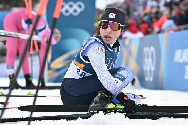 Japan's Masae Tsuchiya reacts after crossing the finish line of the women's cross country 10km + 10km skiathlon event of the Milano Cortina 2026 Winter Olympic Games at Tesero Cross-Country Skiing Stadium in Lago di Tesero (Val di Fiemme) on February 7, 2026. (Photo by Javier SORIANO / AFP)