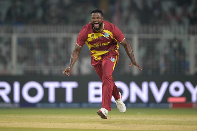 West Indies' Romario Shepherd celebrates after taking the hat trick wicket during the 2026 ICC Men's T20 Cricket World Cup group stage match between Scotland and West Indies at the Eden Gardens in Kolkata on February 7, 2026. (Photo by Dibyangshu SARKAR / AFP)