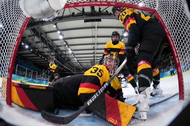 Germany's goalkeeper #35 Sandra Abstreiter saves a goal during the women's preliminary round Group B Ice Hockey match between Germany and Japan at the Milano Rho Ice Hockey Arena at the Milano Cortina 2026 Winter Olympic Games in Milan, on February 7, 2026. (Photo by Sun Fei / POOL / AFP)