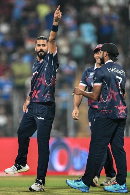 USA's Ali Khan (L) celebrates with teammates after taking the wicket of India's Abhishek Sharma during the 2026 ICC Men's T20 Cricket World Cup group stage match between India and USA at the Wankhede Stadium in Mumbai on February 7, 2026. (Photo by Punit PARANJPE / AFP)