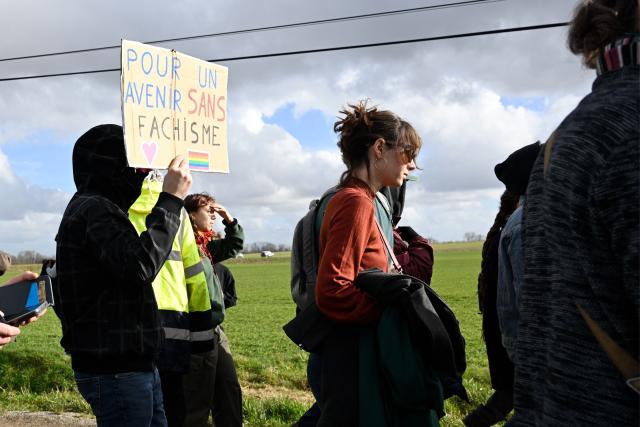 A protester holds a sign reading "For a future without facism" as members of the collective “Fermez la!” demonstrate for the closure of a hangar, "La Taverne de Thor", that has hosted MMA gatherings and neo-Nazi concerts for over ten years in Combres-sous-les-Cotes, northeastern France, on February 7, 2027. (Photo by Jean-Christophe VERHAEGEN / AFP)