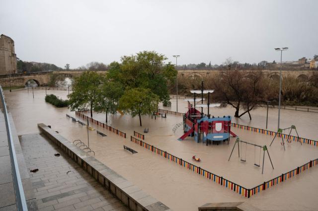A flooded children's playground is seen near the Guadalquivir River in Cordoba on February 7, 2026. Spain and Portugal on February 7, 2026 braced for another storm heading for the Iberian peninsula, just days after the floods caused by Storm Leonardo killed at least one person in each country. (Photo by JORGE GUERRERO / AFP)