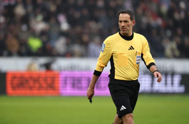 German referee Benjamin Brand reacts during the German first division Bundesliga football match between St Pauli and VfB Stuttgart in Hamburg, northern Germany, on February 7, 2026. (Photo by Ibrahim OT / AFP) / DFL REGULATIONS PROHIBIT ANY USE OF PHOTOGRAPHS AS IMAGE SEQUENCES AND/OR QUASI-VIDEO