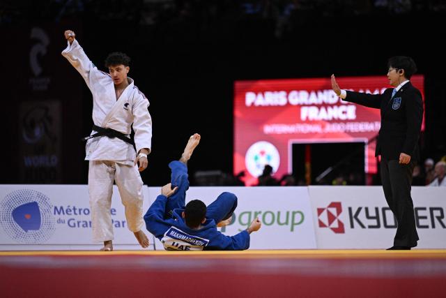 France's Dayyan Boulemtafes (L) reacts as he competes against United Arab Emirates' Makhmadbek Makhmadbekov (C) during the men's -73kg Semi-Final at the Paris Grand Slam judo tournament in Paris on February 7, 2026. (Photo by Julie SEBADELHA / AFP)