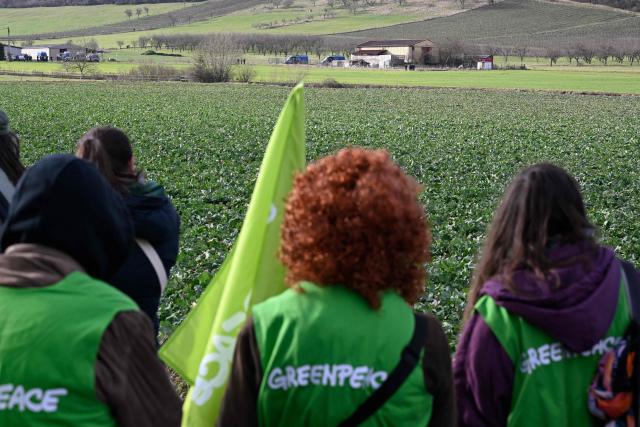 Members of the collective “Fermez la!” look on as they take part in a demonstration for the closure of a hangar, "La Taverne de Thor", that has hosted MMA gatherings and neo-Nazi concerts for over ten years at Combres-sous-les-Cotes, north-eastern France on February 7, 2026. (Photo by Jean-Christophe VERHAEGEN / AFP)
