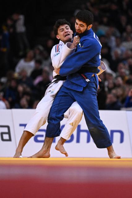 France's Dayyan Boulemtafes (L) competes against United Arab Emirates' Makhmadbek Makhmadbekov (R) during the men's -73kg Semi-Final at the Paris Grand Slam judo tournament in Paris on February 7, 2026. (Photo by Julie SEBADELHA / AFP)