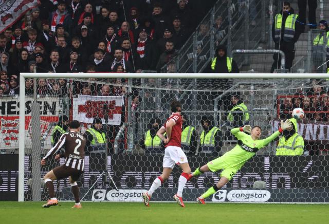 St Pauli's Greek defender #02 Manolis Saliakas (L) scores the 1-0 during the German first division Bundesliga football match between St Pauli and VfB Stuttgart in Hamburg, northern Germany, on February 7, 2026. (Photo by Ibrahim OT / AFP) / DFL REGULATIONS PROHIBIT ANY USE OF PHOTOGRAPHS AS IMAGE SEQUENCES AND/OR QUASI-VIDEO
