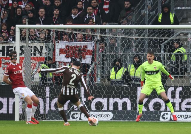 St Pauli's Greek defender #02 Manolis Saliakas (C) shoots to score the 1-0 during the German first division Bundesliga football match between St Pauli and VfB Stuttgart in Hamburg, northern Germany, on February 7, 2026. (Photo by Ibrahim OT / AFP) / DFL REGULATIONS PROHIBIT ANY USE OF PHOTOGRAPHS AS IMAGE SEQUENCES AND/OR QUASI-VIDEO