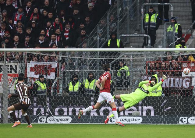 St Pauli's Greek defender #02 Manolis Saliakas (L) scores the 1-0 during the German first division Bundesliga football match between St Pauli and VfB Stuttgart in Hamburg, northern Germany, on February 7, 2026. (Photo by Ibrahim OT / AFP) / DFL REGULATIONS PROHIBIT ANY USE OF PHOTOGRAPHS AS IMAGE SEQUENCES AND/OR QUASI-VIDEO