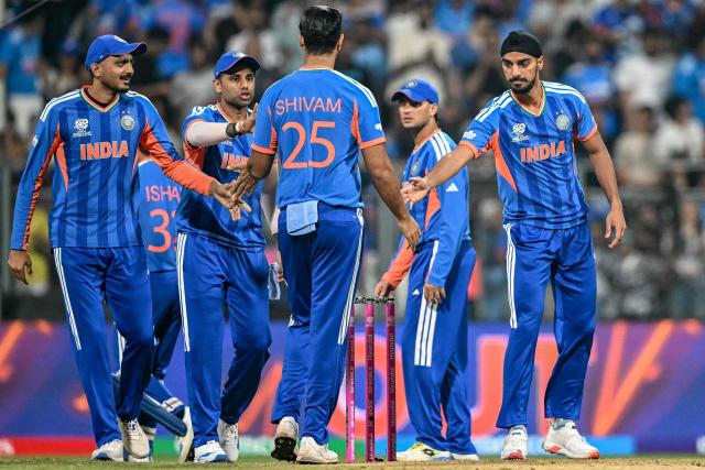 India's Arshdeep Singh (R) celebrates with teammates Suryakumar Yadav (2L), Axar Patel (L) and Shivam Dube (C) after taking the wicket of USA's captain Monank Patel during the 2026 ICC Men's T20 Cricket World Cup group stage match between India and USA at the Wankhede Stadium in Mumbai on February 7, 2026. (Photo by Punit PARANJPE / AFP)