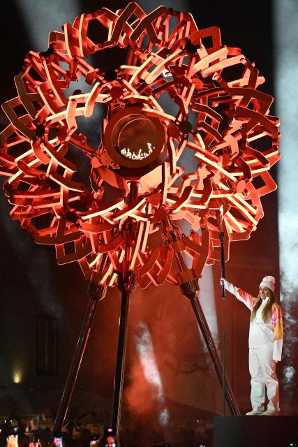 Italy's torchbearer Sofia Goggia lights the cauldron during the opening ceremony of the Milano Cortina 2026 Winter Olympic Games in Cortina d'Ampezzo, northern Italy, on February 6, 2026. (Photo by Tiziana FABI / AFP)
