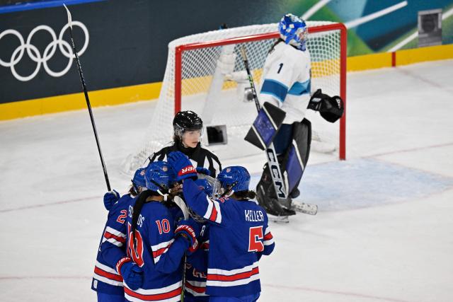 US' players celebrate a team goal  during the women's preliminary round Group A Ice Hockey match between USA and Finland at the Milano Rho Ice Hockey Arena at the Milano Cortina 2026 Winter Olympic Games in Milan, on February 7, 2026. (Photo by Alexander NEMENOV / AFP)