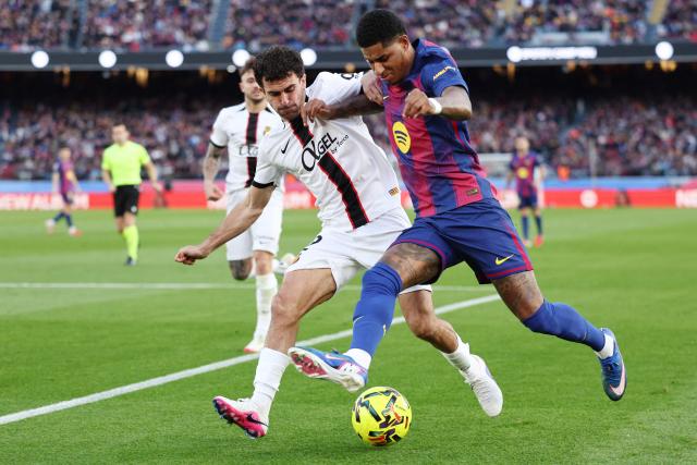 Real Mallorca's Spanish defender #02 Mateu Morey (L) and Barcelona's English forward #14 Marcus Rashford fight for the ball during the Spanish league football match between FC Barcelona and RCD Mallorca at Camp Nou Stadium in Barcelona on February 7, 2026. (Photo by Josep LAGO / AFP)