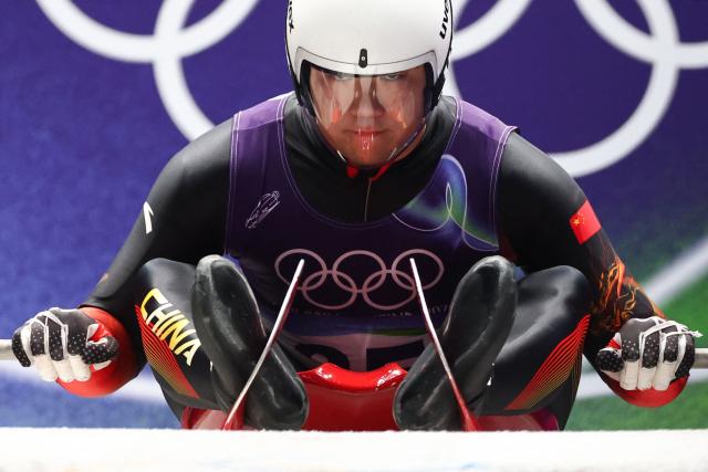 China's Bao Zhenyu takes the start to compete in the luge men's singles run 1 at Cortina Sliding Centre during the Milano Cortina 2026 Winter Olympic Games in Cortina d'Ampezzo on February 7, 2026. (Photo by FRANCK FIFE / AFP)