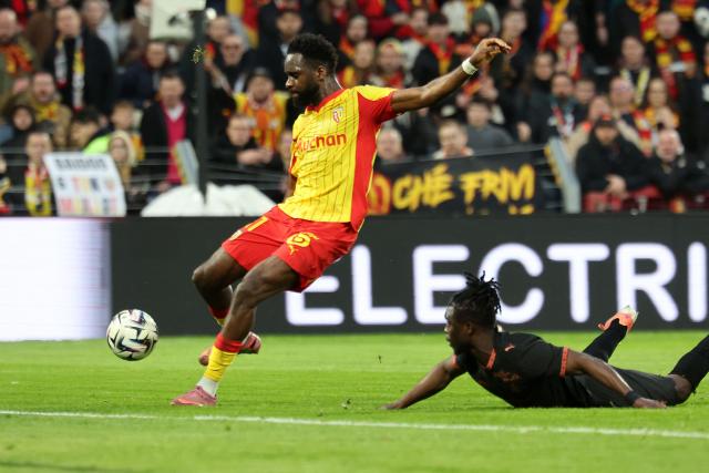 Lens' French forward #11 Odsonne Edouard scores his team's first goal during the French L1 football match between RC Lens and Stade Rennais FC at the Stade Bollaert-Delelis in Lens, northern France on February 7, 2026. (Photo by Francois LO PRESTI / AFP)