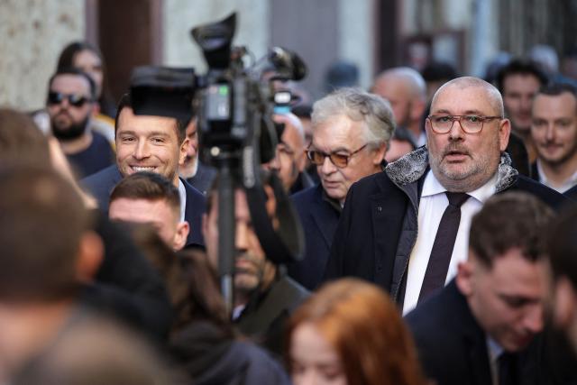 President of French far-right Rassemblement National (RN) party and Member of the European Parliament Jordan Bardella (L) walks with RN candidate for Mayor of Carcassonne, Christophe Barthes (R), in Carcassonne, south-western France, on February 7, 2026. (Photo by Valentine CHAPUIS / AFP)