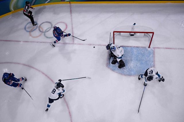 US' forward #21 Hilary Knight (top L) scores a goal  during the women's preliminary round Group A Ice Hockey match between USA and Finland at the Milano Rho Ice Hockey Arena at the Milano Cortina 2026 Winter Olympic Games in Milan, on February 7, 2026. (Photo by Alexander NEMENOV / AFP)