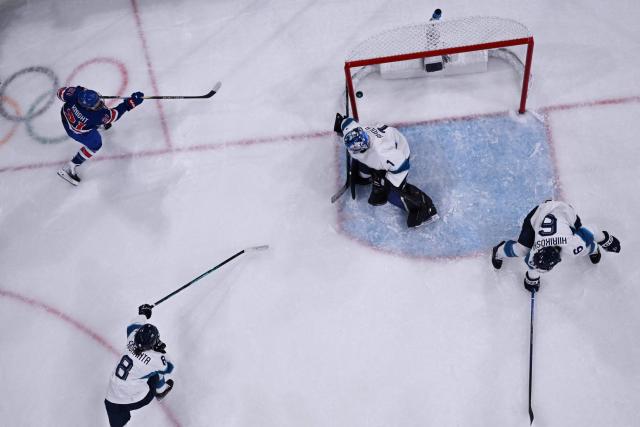 US' forward #21 Hilary Knight (top L) scores a goal  during the women's preliminary round Group A Ice Hockey match between USA and Finland at the Milano Rho Ice Hockey Arena at the Milano Cortina 2026 Winter Olympic Games in Milan, on February 7, 2026. (Photo by Alexander NEMENOV / AFP)