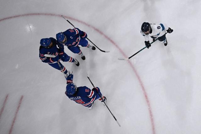 US' forward #21 Hilary Knight (3rd L) celebrates scoring a goal  during the women's preliminary round Group A Ice Hockey match between USA and Finland at the Milano Rho Ice Hockey Arena at the Milano Cortina 2026 Winter Olympic Games in Milan, on February 7, 2026. (Photo by Alexander NEMENOV / AFP)