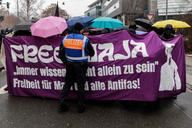 Supporters of German anti-fascist activist Maja T, who was sentenced to eight years in prison in Budapest, take part in a demonstration in support of her on February 7, 2026 in Jena, eastern Germany. The 25-year-old non-binary person was sentenced in Budapest to eight years in prison for an attack on right-wing extremists in February 2023 in Hungary. The trial was controversial because Maja T. had been extradited from Germany to Hungary, which is governed by a right-wing nationalist administration, despite an urgent appeal before the Federal Constitutional Court. (Photo by JENS SCHLUETER / AFP)
