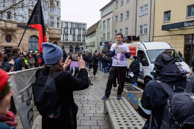Father Wolfram Jarosch of German anti-fascist activist Maja T, who was sentenced to eight years in prison in Budapest, speaks during a demonstration in support of her on February 7, 2026 in Jena, eastern Germany. The 25-year-old non-binary person was sentenced in Budapest to eight years in prison for an attack on right-wing extremists in February 2023 in Hungary. The trial was controversial because Maja T. had been extradited from Germany to Hungary, which is governed by a right-wing nationalist administration, despite an urgent appeal before the Federal Constitutional Court. (Photo by JENS SCHLUETER / AFP)