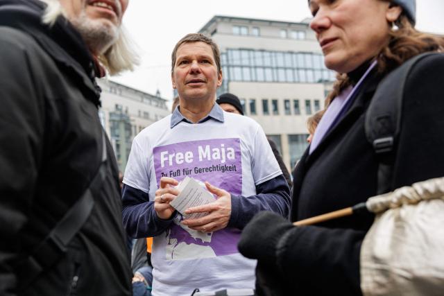 Father Wolfram Jarosch of German anti-fascist activist Maja T, who was sentenced to eight years in prison in Budapest, attends a demonstration in support of her on February 7, 2026 in Jena, eastern Germany. The 25-year-old non-binary person was sentenced in Budapest to eight years in prison for an attack on right-wing extremists in February 2023 in Hungary. The trial was controversial because Maja T. had been extradited from Germany to Hungary, which is governed by a right-wing nationalist administration, despite an urgent appeal before the Federal Constitutional Court. (Photo by JENS SCHLUETER / AFP)