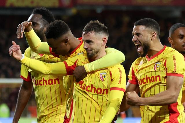 Lens' French defender #02 Ruben Aguilar (C) celebrates with teammates after scoring his team's second goal during the French L1 football match between RC Lens and Stade Rennais FC at the Stade Bollaert-Delelis in Lens, northern France on February 7, 2026. (Photo by Francois LO PRESTI / AFP)