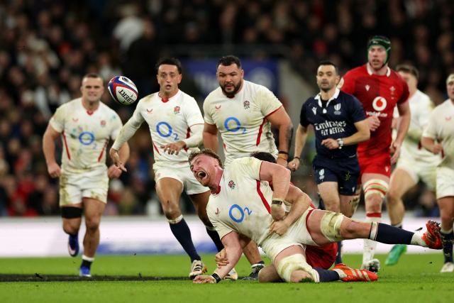 England's lock Ollie Chessum is tackled by Wales' scrum-half Tomos Williams during the Six Nations international rugby union match between England and Wales at Allianz Stadium, Twickenham, in south-west London, on February 7, 2026. (Photo by Adrian Dennis / AFP)