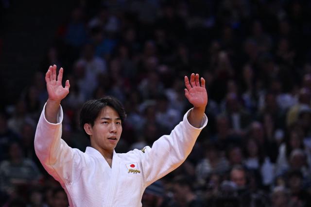 Japan's Takeshi Takeoka celebrates after winning against South Korea's Channyeong Kim in the men's -66kg Final bout at the Paris Grand Slam judo tournament in Paris on February 7, 2026. (Photo by Julie SEBADELHA / AFP)