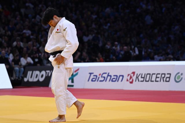 Japan's Takeshi Takeoka (in white) competes against South Korea's Channyeong Kim in the men's -66kg Final bout at the Paris Grand Slam judo tournament in Paris on February 7, 2026. (Photo by Julie SEBADELHA / AFP)