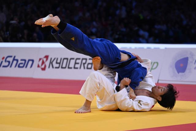 Japan's Takeshi Takeoka (in white) competes against South Korea's Channyeong Kim in the men's -66kg Final bout at the Paris Grand Slam judo tournament in Paris on February 7, 2026. (Photo by Julie SEBADELHA / AFP)