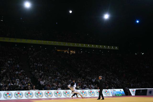 France's Amandine Buchard (in blue) competes against South Korea's Seyung Jang in the women's -52kg Bronze medal bout at the Paris Grand Slam judo tournament in Paris on February 7, 2026. (Photo by Julie SEBADELHA / AFP)