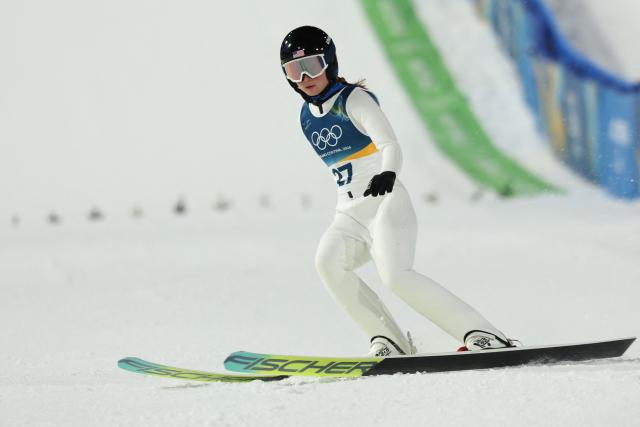 USA's Annika Belshaw arrives in the finish area after jumping during the women's ski jumping normal hill individual 1st round of the Milano Cortina 2026 Winter Olympic Games at Predazzo Ski Jumping Stadium in Predazzo (Val di Fiemme), on February 7, 2026. (Photo by Anne-Christine POUJOULAT / AFP)