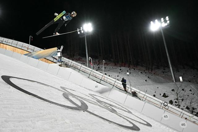 France's Josephine Pagnier jumps during the women's ski jumping normal hill individual 1st round of the Milano Cortina 2026 Winter Olympic Games at Predazzo Ski Jumping Stadium in Predazzo (Val di Fiemme), on February 7, 2026. (Photo by Javier SORIANO / AFP)