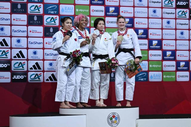 Gold medallist Brazil's Rafaela Silva (2L) stands next to silver medallist Mongolia's Enkhriilen Lkhagvatogoo (L) and bronze medallist  in podium of the women's -63kg Final at the Paris Grand Slam judo tournament in Paris on February 7, 2026. (Photo by Julie SEBADELHA / AFP)