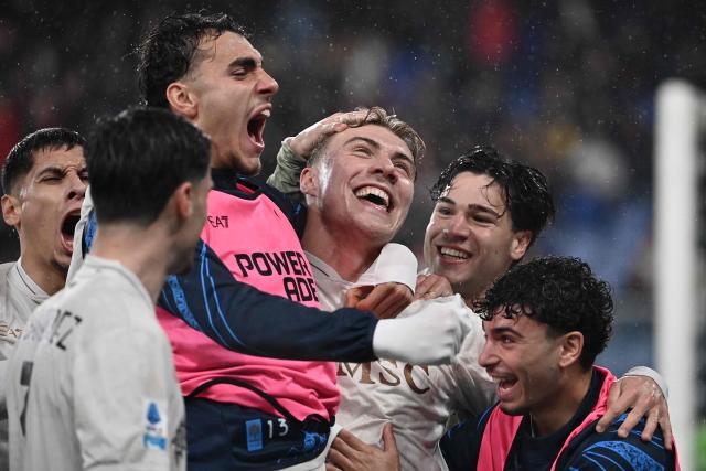 Napoli's Danish forward #19 Rasmus Hojlund celebrates with teammates after scoring a penalty during the Italian Serie A football match between Genoa and Napoli at the Luigi Ferraris stadium in Genoa on February 7, 2026. (Photo by Isabella BONOTTO / AFP)