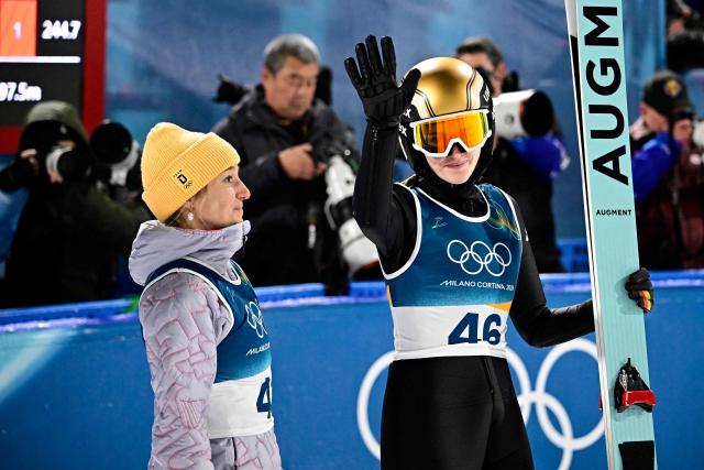 Germany's Selina Freitag (R) gestures after competing during the women's ski jumping normal hill individual final round of the Milano Cortina 2026 Winter Olympic Games at Predazzo Ski Jumping Stadium in Predazzo (Val di Fiemme), on February 7, 2026. (Photo by Tobias SCHWARZ / AFP)