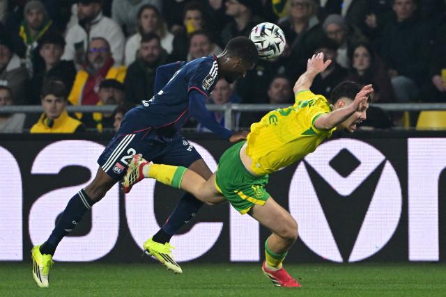 Lyon’s Angolan defender #22 Clinton Mata (L) fights for the ball with Nantes’ French forward #10 Matthis Abline during the French L1 football match between FC Nantes and Olympique Lyonnais (OL) at the Stade de la Beaujoire–Louis Fonteneau in Nantes, western France on February 7, 2026. (Photo by Damien Meyer / AFP)