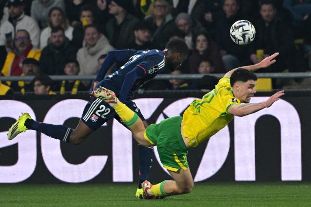 Lyon’s Angolan defender #22 Clinton Mata (L) fights for the ball with Nantes’ French forward #10 Matthis Abline during the French L1 football match between FC Nantes and Olympique Lyonnais (OL) at the Stade de la Beaujoire–Louis Fonteneau in Nantes, western France on February 7, 2026. (Photo by Damien Meyer / AFP)