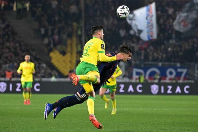 Nantes’ French defender #18 Fabien Centonze (L) fights for the ball with Lyon’s Portuguese forward #17 Afonso Bastardo Moreira (C) during the French L1 football match between FC Nantes and Olympique Lyonnais (OL) at the Stade de la Beaujoire–Louis Fonteneau in Nantes, western France on February 7, 2026. (Photo by Damien Meyer / AFP)