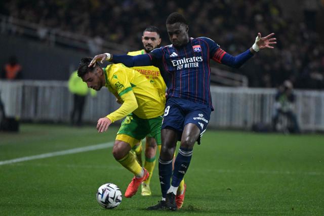 Nantes’ French defender #18 Fabien Centonze (L) fights for the ball with Lyon’s Senegalese defender #19 Moussa Niakhate during the French L1 football match between FC Nantes and Olympique Lyonnais (OL) at the Stade de la Beaujoire–Louis Fonteneau in Nantes, western France on February 7, 2026. (Photo by Damien Meyer / AFP)