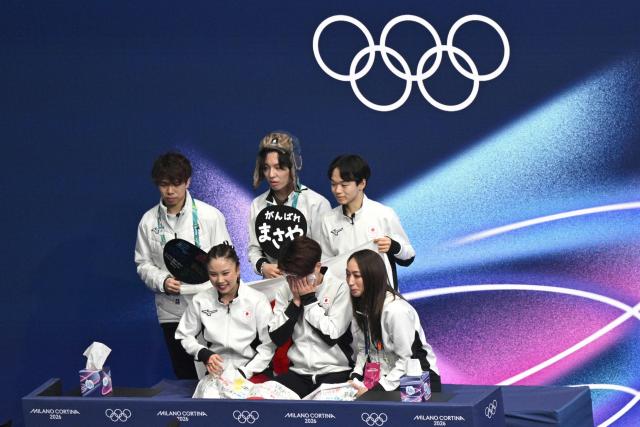 Japan's Utana Yoshida (front R) and Japan's Masaya Morita (front L) react in the kiss and cry area after competing in the figure skating team event ice dance-free dance during the Milano Cortina 2026 Winter Olympic Games at Milano Ice Skating Arena in Milan on February 7, 2026. (Photo by Antonin THUILLIER / AFP)