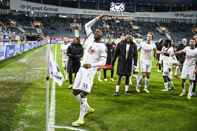 OH Leuven's Swiss-Togolese defender #34 Roggerio Nyakossi (3L) celebrates Leuven's victory with teammates at the end of the Belgian "Pro League" First Division football match between KAA Gent and Oud-Heverlee Leuven at the KAA Stadium in Ghent on February 7, 2026. (Photo by Tom Goyvaerts / Belga / AFP) / Belgium OUT