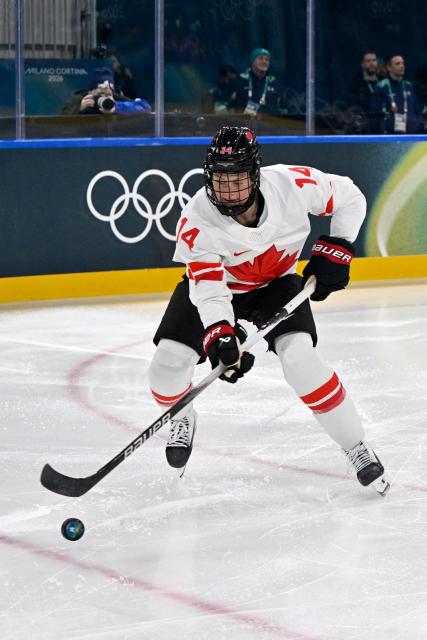 Canada's #14 Renata Fast controls the puck during the women's preliminary round Group A Ice Hockey match between Switzerland and Canada at the Milano Rho Ice Hockey Arena at the Milano Cortina 2026 Winter Olympic Games in Milan, on February 7, 2026. (Photo by Alexander NEMENOV / AFP)